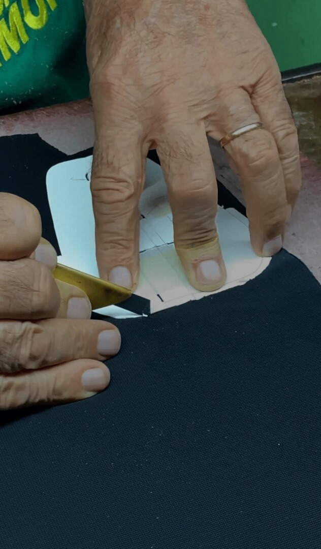artisan cutting leather in Nasini Giorgio's NGM shoe factory for private label service